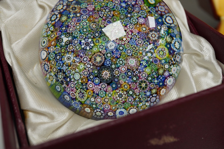 Two boxed Perthshire glass paperweights, the first faceted with latticino twists and complex canes, the second close packed millefiori paperweight, 62/400